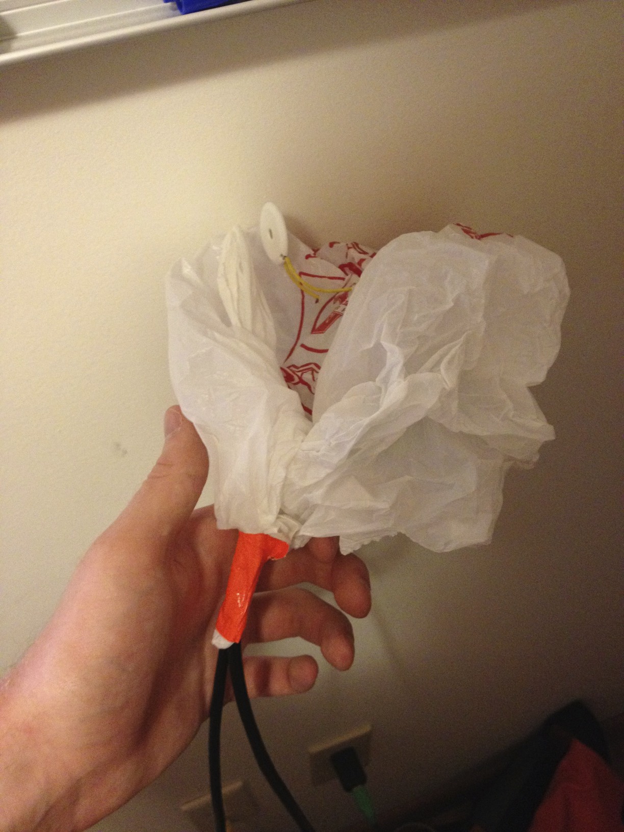 The noise device, wrapped in a plastic bag